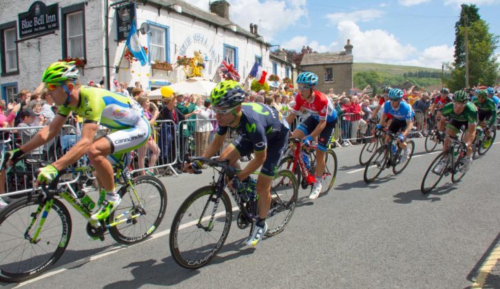 Finally, the peloton streams through Kettlewell in North Yorkshire