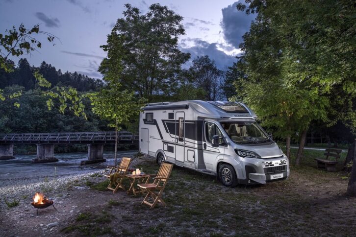 Adria Matrix parked up beside a campfire