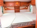 A hinged wooden flap and two filler cushions transform the two singles into a huge comfortable double bed in this Hymer