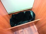 One of the steps to the rear bed area lifts up to reveal a storage cubby with a handy built-in bag – useful for keeping laundry out of sight