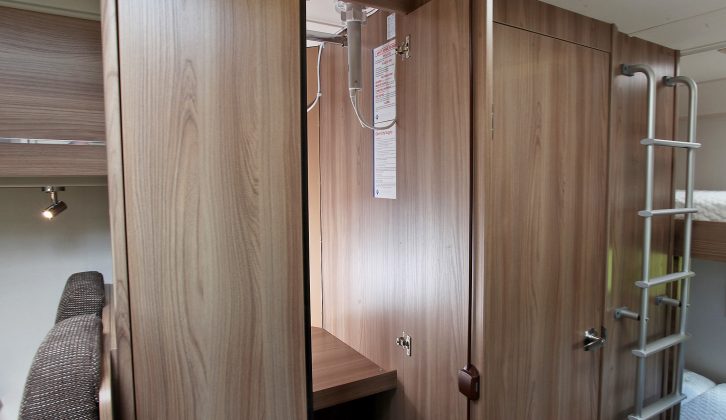 The large wardrobe has hanging space and a shelf, where you’ll find the TV aerial – below the wardrobe is the heater