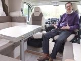 Inside the Pilote Pacific P716P's large lounge, with Practical Motorhome's Editor Niall Hampton