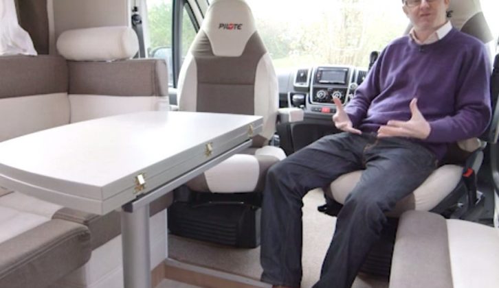 Inside the Pilote Pacific P716P's large lounge, with Practical Motorhome's Editor Niall Hampton