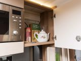 The 2015 Swift Esprit 494 has two overhead cupboards either side of the microwave. The one on the right has good headroom and easily passes the cereal box test