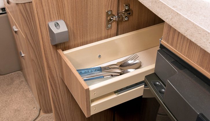 There's a narrow cutlery drawer between the oven and fridge, with a cupboard beneath for storing the detachable drainer in the Swift Esprit 494's kitchen