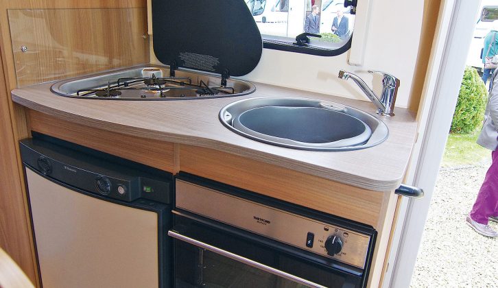 The well lit kitchen in the Bailey Approach Advance 615 motorhome has a tiny worktop, but there's a combined oven and grill, an 80-litre fridge-freezer, three-burner hob, and sink