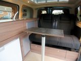 This versatile living space is a lounge-dining-kitchen area, with room for three to eat at the table if you rotate the passenger cab seat in Hillside Leisure's Dalbury E electric campervan, based on the Nissan e-NV200 Combi Acenta