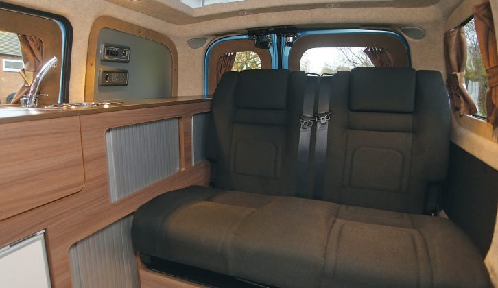 The RIB rear seat bench provides two travel seats, while storage space is available underneath, and in the kitchen unit of the Dalbury E camper