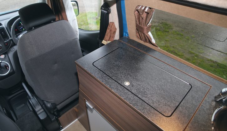 If you move the driver's seat forwards you can then slide a section of the kitchen worktop to reveal the gas hob with its twin-burners in Hillside Leisure's electric camper