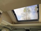 The panoramic sunroof above the cab supplements the daylight that pours in through the windows in the front lounge of the Roller Team T-Line 590 compact motorhome
