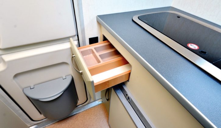 The the Nu Rio Micro's kitchen has a cutlery drawer and cupboard and there is room for an optional oven/grill, and the motorhome's rear stable door has a waste bin attached