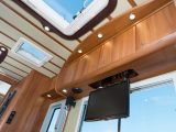 Ribbing in the vinyl ceiling complements the cabinet work’s finish, while an electrically operated, drop-down TV was fitted to our test ’van