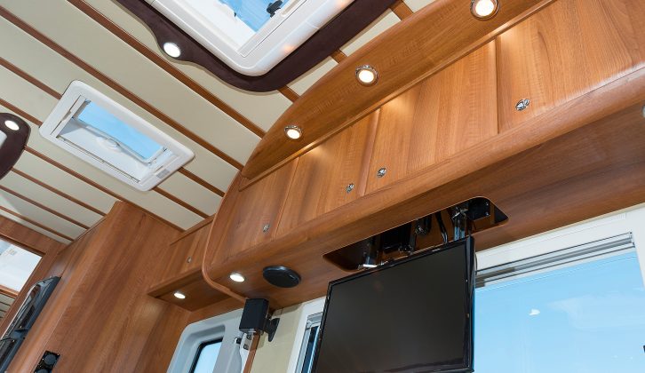 Ribbing in the vinyl ceiling complements the cabinet work’s finish, while an electrically operated, drop-down TV was fitted to our test ’van