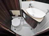 The sink bulkhead is hinged to swing away and form a full-size shower cubicle, allowing optimal storage