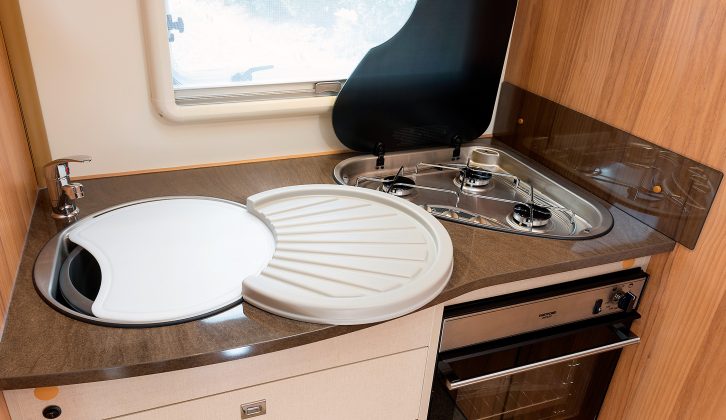 The kitchen comes with a chopping board and clip-on drainer, while the triangular hob’s glass lid doubles as workspace in the Compact 540 motorhome