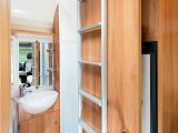 There's a great end washroom with a separate lined shower cubicle partitioned behind a bi-fold door – and clips for the ladder in the Bailey Approach Compact 540