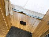 Below the rear bed is a wooden aperture that divides the bedroom from the rest of the habitation area – and there's a slot in it so that you can store long thin things such as skis