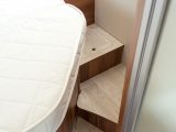 The steps around both sides of the fixed bed in the T-Line 740 have good clearance and offer handy storage cubbies for items you need to access quickly