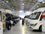 Stacks of new and used motorhomes for sale fill the former electrical distribution warehouse