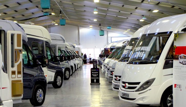 Stacks of new and used motorhomes for sale fill the former electrical distribution warehouse
