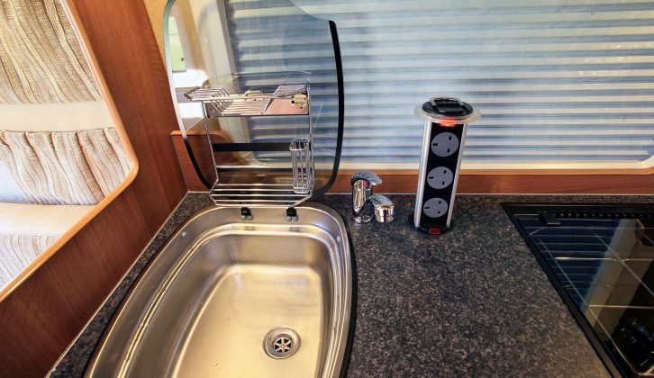 It’s all in the detail – when you lift the cover on the good-sized sink you’ll find a utensil rack. We also like the 12V gang of three retractable power sockets in the Shire