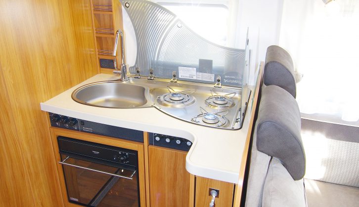 The L-shaped kitchen offers very little worktop area. Some space is redeemed with the glass lid to the sink and hob, and there is an oven in the Dethleffs Esprit T7150 DBM motorhome
