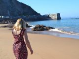 Kate sinks her toes into the sand on the beach at Greve de Lecq in Jersey