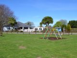 Safety surfaces are beneath the equipment in the children's play area at Beuvelande Campsite on Jersey – and the restaurant is shown just beyond it