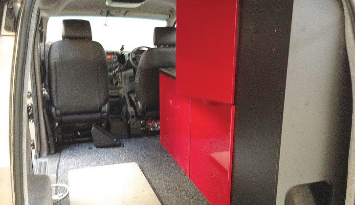 A conventional offside array of cupboards, with a tall one towards the rear, in this Nissan campervan conversion