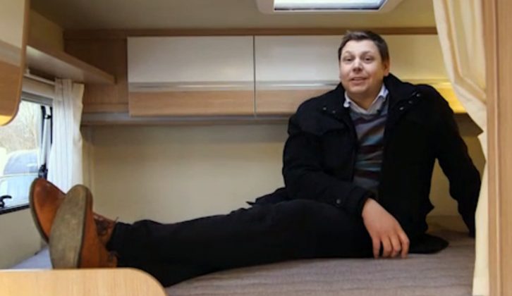 Practical Motorhome's tall Group Editor Alastair Clements tests the bed sizes in the Sunlight T60 on TV
