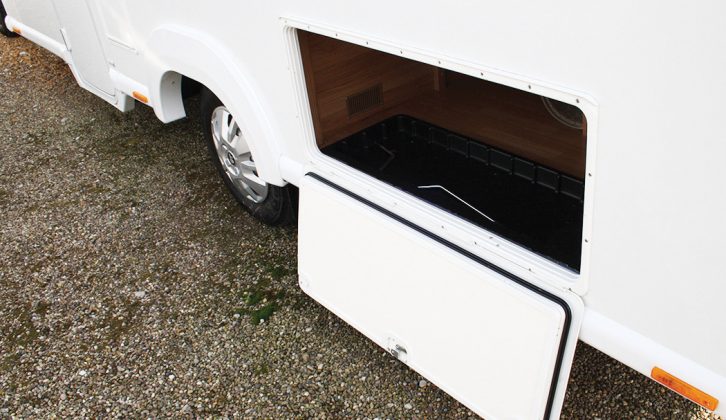An enormous locker door gives external access to the storage space under the fixed transverse double bed in the Approach Autograph 730 – ideal for storing folding camping chairs