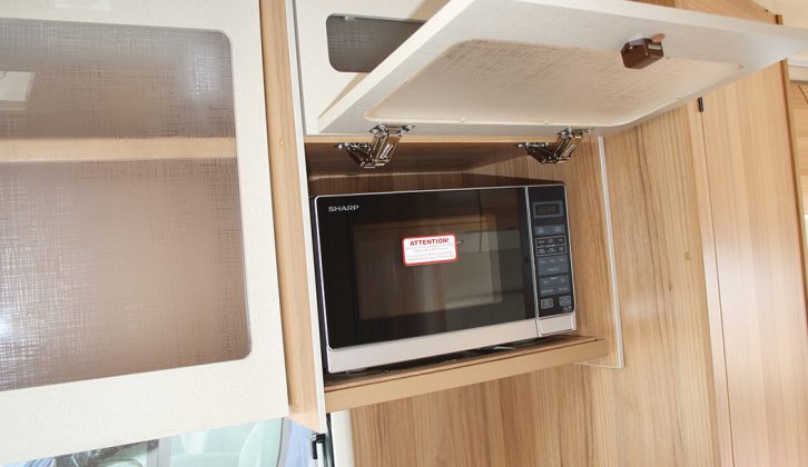 The microwave is tucked discreetly away in an overhead roof locker, although it would be better placed over the worktop rather than the hob