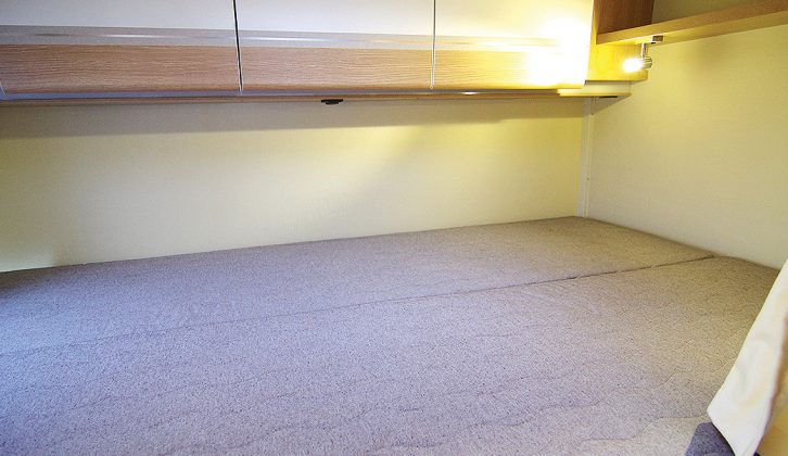 The huge double bed is a highlight of this motorhome layout, making it ideal for active couples who appreciate the storage garage beneath for sports gear
