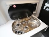 The hob has three gas burners and is integrated with the sink, with one lid covering the lot, which makes a handy work surface in the kitchen