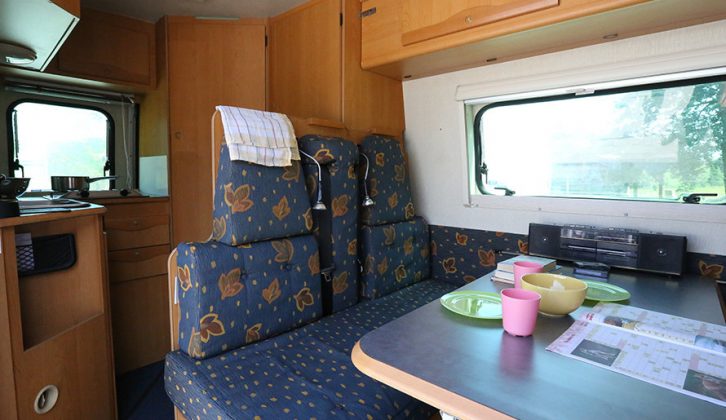 Features of this 2000 Adria Van include an L-shaped kitchen and a bathroom