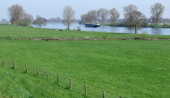 Big canals and rivers (here, the Maas), flat open landscapes, fields of grazing cows and big skies typify the landscape of the Netherlands
