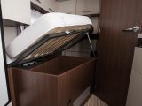 The French bed in this motorhome conceals sectioned storage beneath. We think the metal stay could do with being a bit longer than it is currently