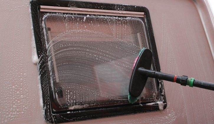 Wash your soft brush to get rid of any gritty bits before you use it  to clean the windows