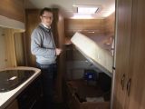 Fixed beds with gas struts offer excellent storage space, as Niall demonstrates in the Elddis Autoquest 155