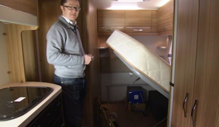 Fixed beds with gas struts offer excellent storage space, as Niall demonstrates in the Elddis Autoquest 155