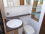 The spacious, airy washroom is split in two, with the toilet, vanity area and washbasin against the nearside wall