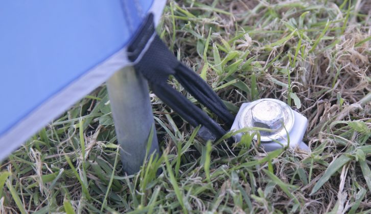 Pegging your windbreak down like a tent gives it half a chance of staying put in fairly strong breezes