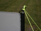 The windbreak fabric is hung from each pole spike, which the guy lines simply tie onto as well