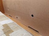 Cut gaps at the base of the panel to allow more air to flow, then place it at the back of the sofa