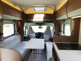 A freestanding table fits between the parallel lounge seats at mealtimes – read more in the Practical Motorhome Auto-Trail Imala 715 review