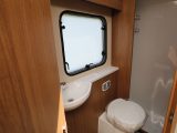 The washroom has a swivel-seat cassette toilet, a good-size basin, lockers and a smoked-glass window – beyond is the shower