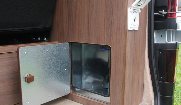 The gas locker is low down in the rear-offside corner; on the outside of the cabinet is the connection for the shower attachment