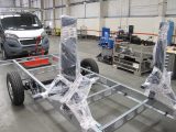 Seat and safety belt assemblies for interior travel seating (protected here in polythene sheet) can be bolted directly through a ply floor-panel and into the chassis below to create full anchorage