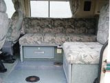 From the side door you can see storage drawer fronts and the location of the island leg table in this 'van from Auto-Sleepers