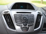 The car-like dashboard has a neat central console with a CD player and auxiliary audio input